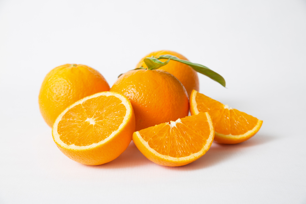 cut-whole-orange-fruits-with-green-leaves
