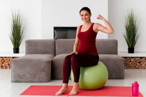 front-view-young-pregnant-woman-using-fitness-ball
