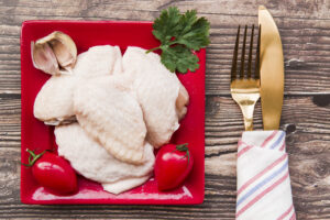 uncooked-meat-ingredients-plate-with-golden-fork-butter-knife